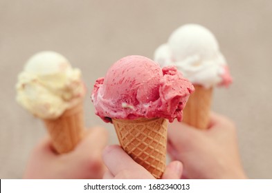 Three cornets of ice cream - strawberry, vanilla, lemon