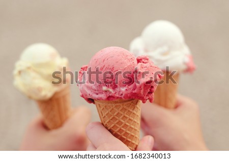 Three cornets of ice cream - strawberry, vanilla, lemon