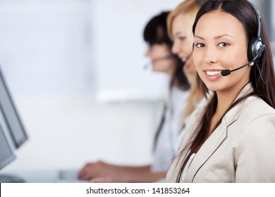 Three Costumer Service Executives With Headset In The Office