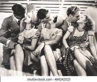 Three Couples Kissing