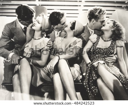 Three couples kissing