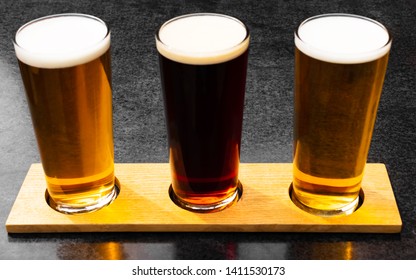 Three Craft Ales In A Beer Garden Lined Up And Shot From Above In The Summer Sun