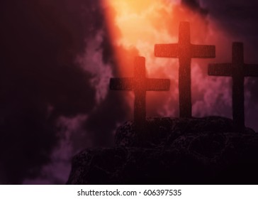 three cross on the hill  in dark cloudy with light from above. can be use for Easter or Christian background, copy space