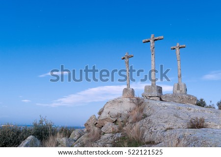 Three Crosses of carved stone on granite rock at dusk of Heaven Foto stock © 