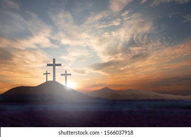 Three crosses on the mountain Jesus Christ with a sunset background - Shutterstock ID 1566037918