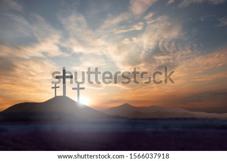 Three crosses on the mountain Jesus Christ with a sunset background