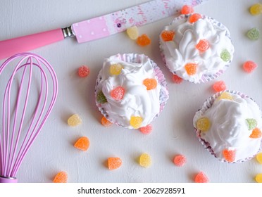 Three Cupcakes With Jelly Beans On Bright White Background. Cupcakes With Knife And Orange, Red, Pink Jellybeans.