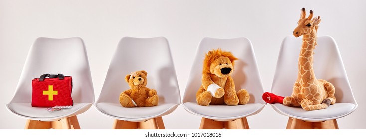 Three cute stuffed animal toys on chairs in the waiting room of a modern hospital or health center for children