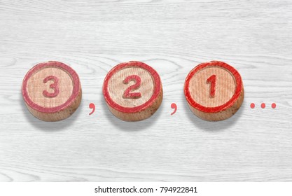 Three cylinder-shaped wooden pieces on a white wood background depicting the countdown from three to one - Powered by Shutterstock