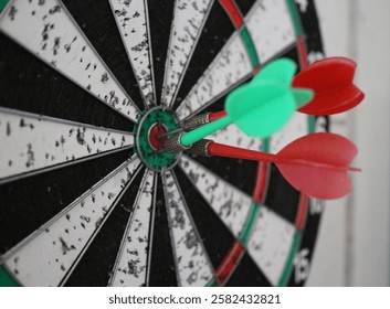 Three darts hit precisely in the center of target board, as symbol of accuracy, focus and  and achievement