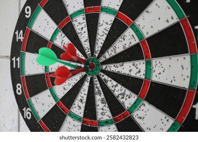 Three darts hit precisely in the center of target board, as symbol of accuracy, focus and  and achievement