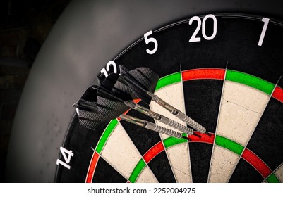 Three darts in triple twenty on professional sisal steeldart. perfect 180 highscore shot dart game hobby sport concept background.