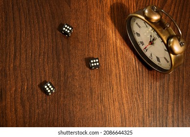 three dice with a drawn sixes on the oak table, next to the clock showing almost 12 o'clock