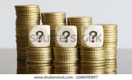 Three dice with question marks on coin towers