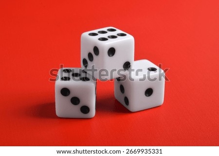 Three dices isolated on red background