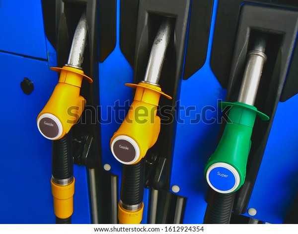 Three diesel and super unleaded 95 pumps, yellow\
and green, at a service\
station