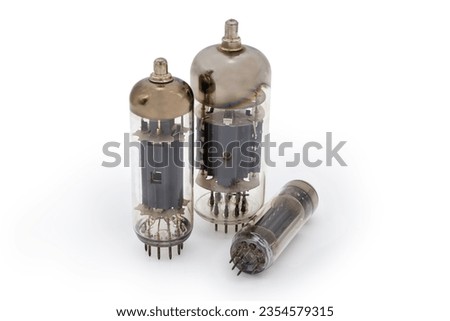 Three different old electronic amplifying vacuum tubes on a white background
