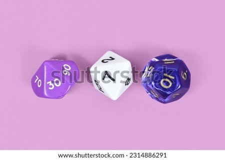 Three different roleplaying RPG dice on violet background