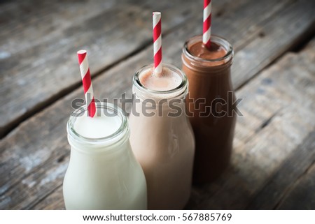 Three Different Sorts Beverage Milk Cocoa Chocolate Bottle Wooden Background