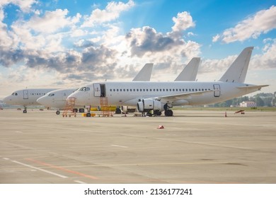 Three different types of aircraft lined up on the airport apron
