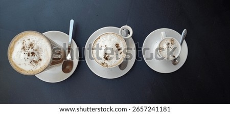 three different types of coffee, espresso, cappuccino, and latte served outdoors at a ?afe in Portugal. Concept of the countrys coffee culture and beverage themes.