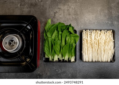 Three different types of vegetables are displayed on a countertop, including green beans, asparagus, and mushrooms