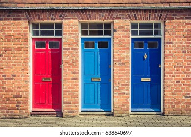 Three differently coloured front doors at the entrance of old English terraced houses. Canterbury, England. - Powered by Shutterstock