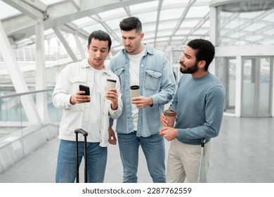 Three Displeased Males Using Smartphone Having Problem With Mobile Internet Connection Standing In Modern Airport Indoor. Guys Having Issue Booking Tickets In Travel Application - Shutterstock ID 2287762559