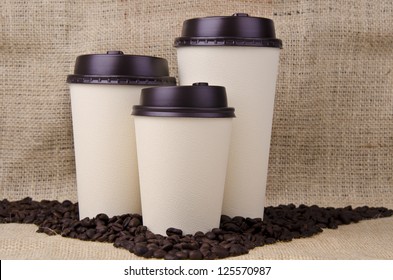 Three disposable coffee cups with plastic lid. - Powered by Shutterstock