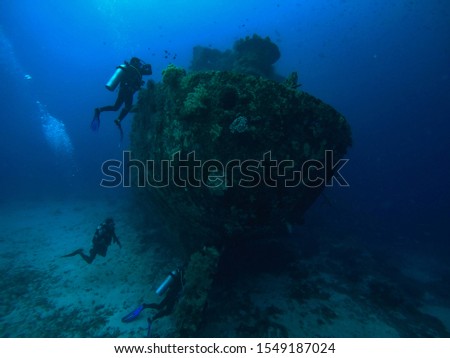 Three divers checking out the stern of an old Indonesian fishing boat wreck sank near Rabaul, Papua New Guinea