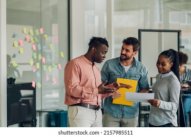 Three diverse business team discussing and planning projects using analytical papers during a meeting in the office. Business and finance concept. Multiracial business colleagues checking documents. - Shutterstock ID 2157985511