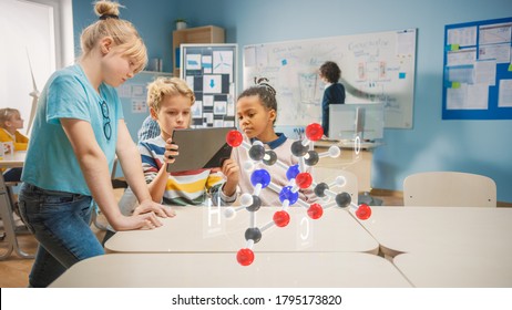 Three Diverse School Children In Chemistry Science Class Use Digital Tablet Computer With Augmented Reality Application, Looking At Educational 3D Animation Of A Molecule. VFX, Special Effects Render