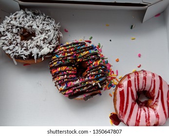 Three Donut Rings with Fancy Toppings - Chocolate, Coconut, Strawberry, Sprinkles and Raspberry ZigZags