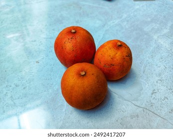 three dry tangerines in the kitchen table