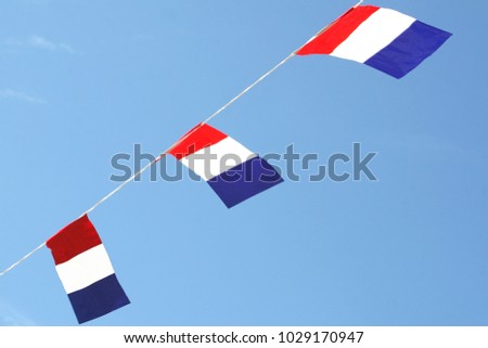 Three Dutch flags waving in blue sky, national holidays, Liberation day (Bevrijdingsdag), Kingsday (Koningsdag) and WK FIFA football sport events