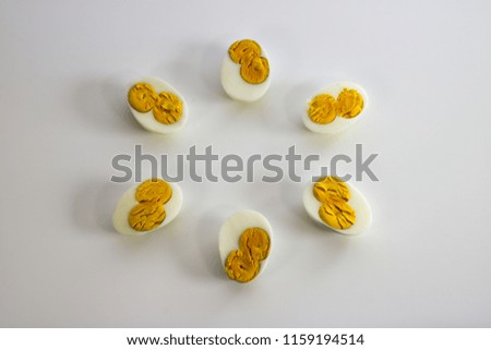 Three eggs cut to half each with two yolks
