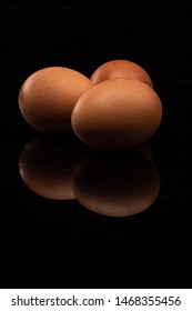 Three Eggs On A Black Shinny Floor