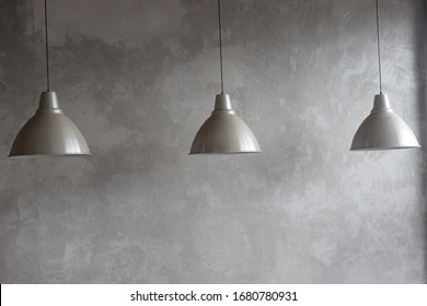 Three electric lamps of gray color on a gray background.