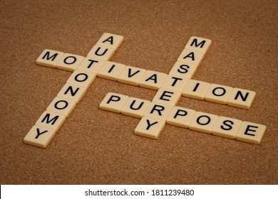 three elements of true motivation - mastery, autonomy, purpose - with ivory letter blocks on board, personal development concept