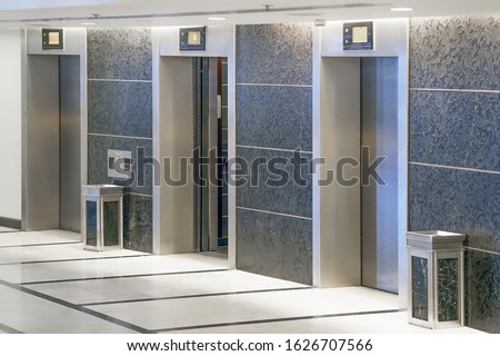 Three elevator doors in office building. Wide angle view of modern elevators with doors. Elevators in the modern lobby house or hotel.                               