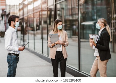 Three Employers Standing In Social Distance Wearing Face Mask Looking At Each Other And Talking