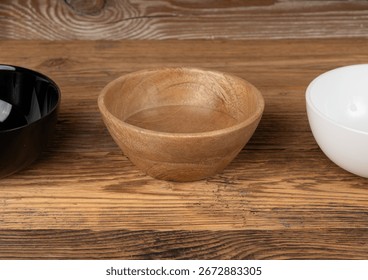 Three empty bowls on table, white porcelain, black and wooden dishes on tabletop, rustic dish mockup, eco bio kitchen desktop banner with copy space for text