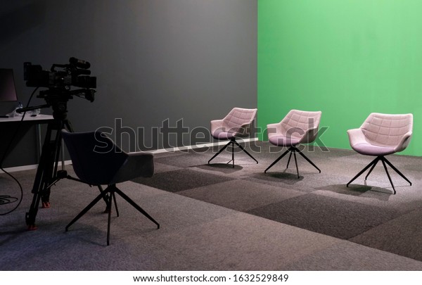 Three empty\
chairs in a TV studio with green\
screen