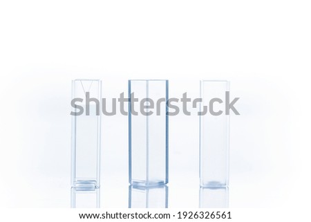 Three empty cuvettes used for measuring the concentration of a solution.