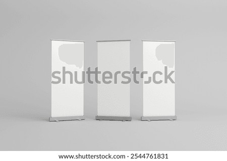 Three empty roll-up banners with white backgrounds, lined up side by side, ideal for customizable branding in exhibitions, trade shows, or promotional events.