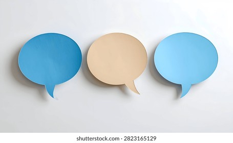 Three empty speech bubbles, two blue and one beige, arranged horizontally on a plain white surface.
