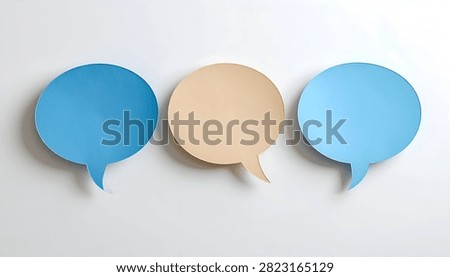 Three empty speech bubbles, two blue and one beige, arranged horizontally on a plain white surface.