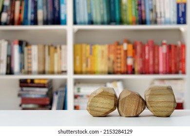 Three Empty Wooden Blocks In Front Of Home Library. Blank Wood Blocks Mockup And Blurred Bookshelf.