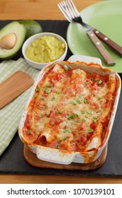 Three Enchiladas In A Baking Dish