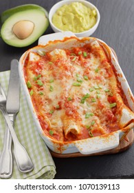 Three Enchiladas In A Baking Dish